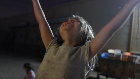young girl from a TC Drupal party raising her arms in celebration